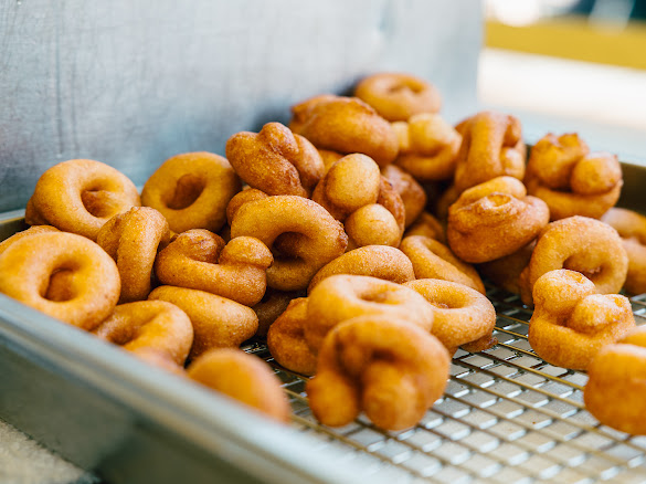 Fresh mini donuts piled on a rack